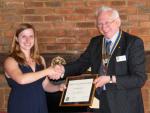 Lyndsey recieves her RYLA certificate from president Alan
